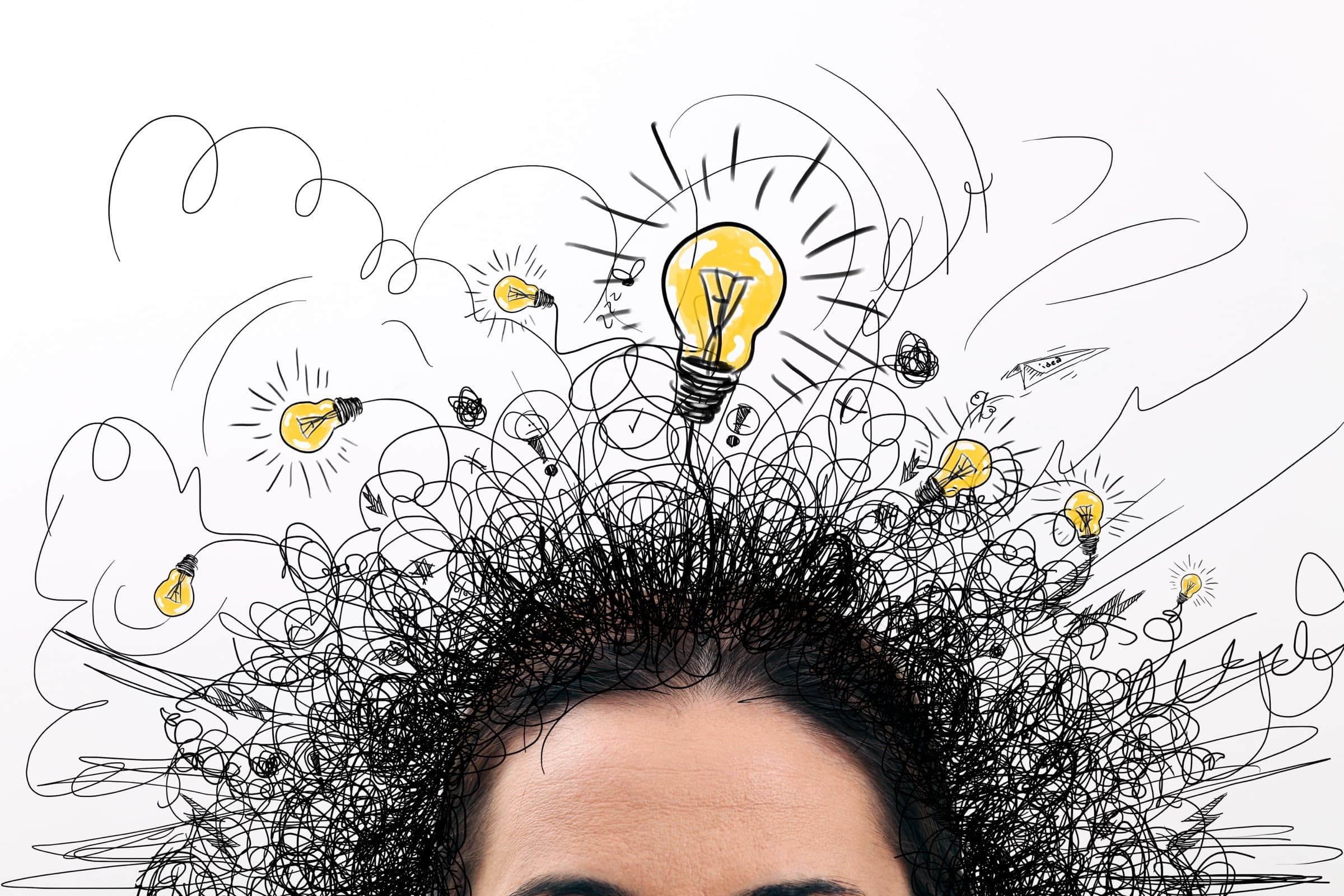 Hand-drawn light bulbs and looping scribbles bursting upward from the top of a person’s head