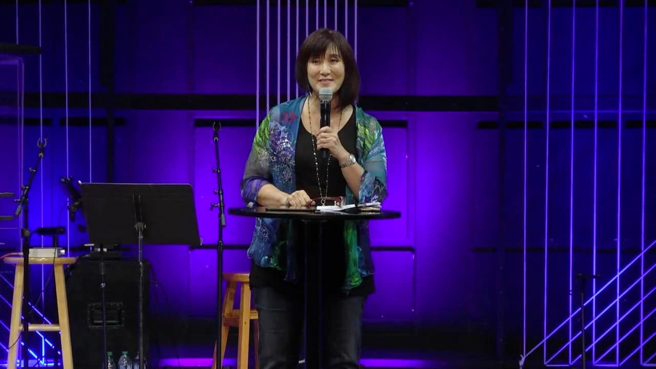 Michele Okimura speaking on stage