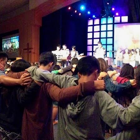 Young people standing arm in arm at the 2014 Explicit conference.